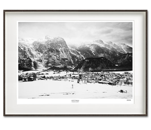 Black and white photo of Abtenau village, Austria, in winter, showcasing holiday magic, winter sports, and majestic mountains.